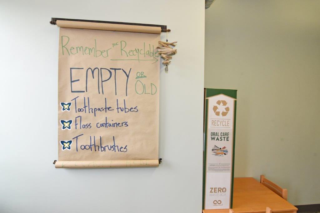 Sign reminding you to recycle old toothpaste tubes, floss containers and toothbrushes